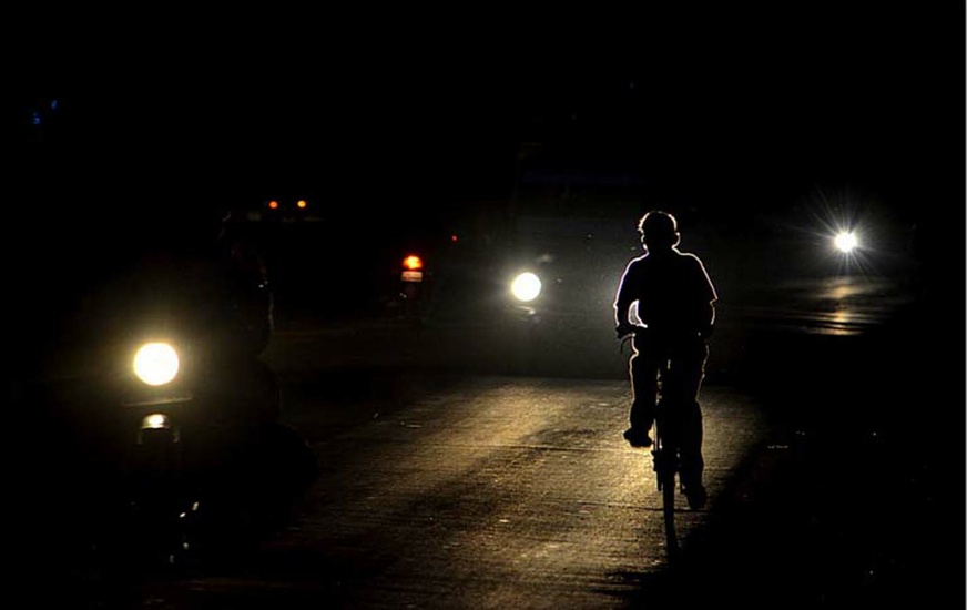 Cyclist riding his bike in the dark