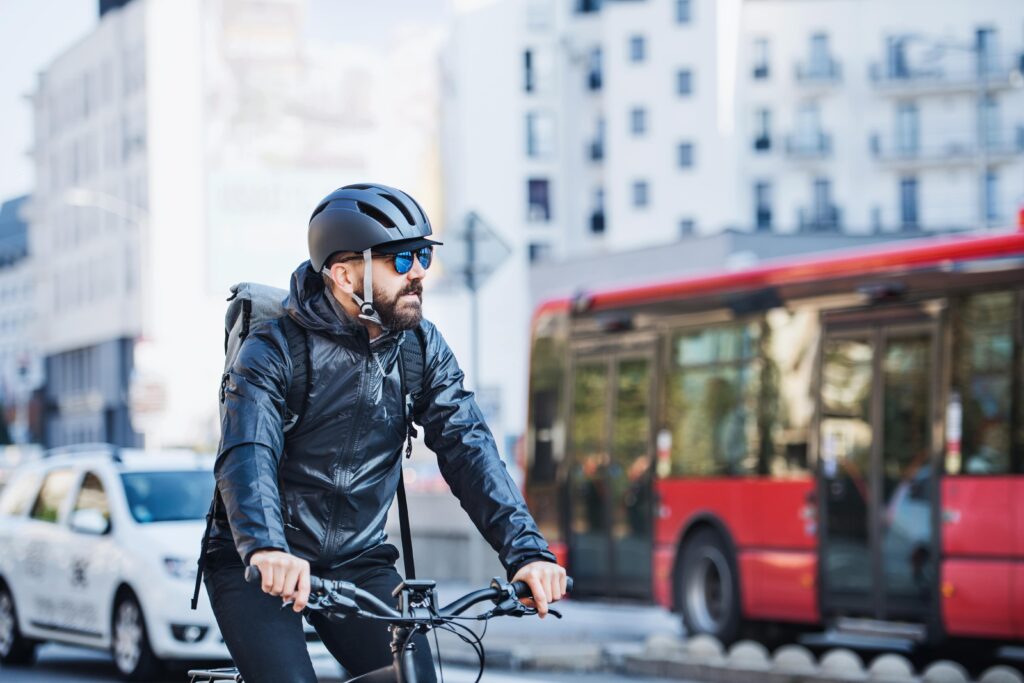 cyclist riding an eBike on a busy road