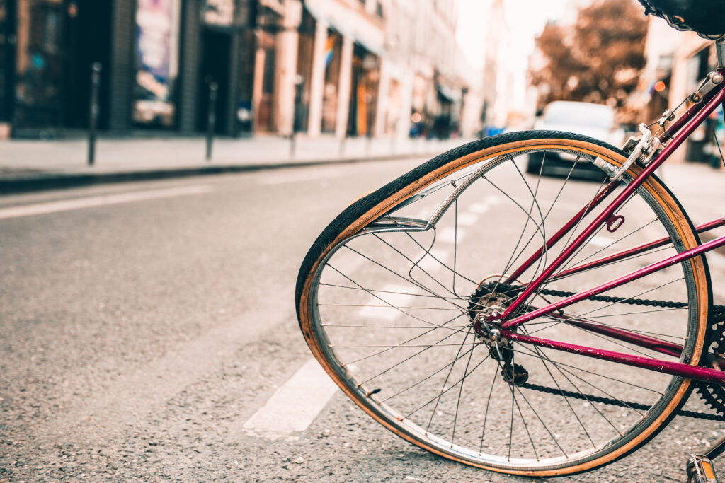 Damaged bicycle with a bent wheel during a road accident collision