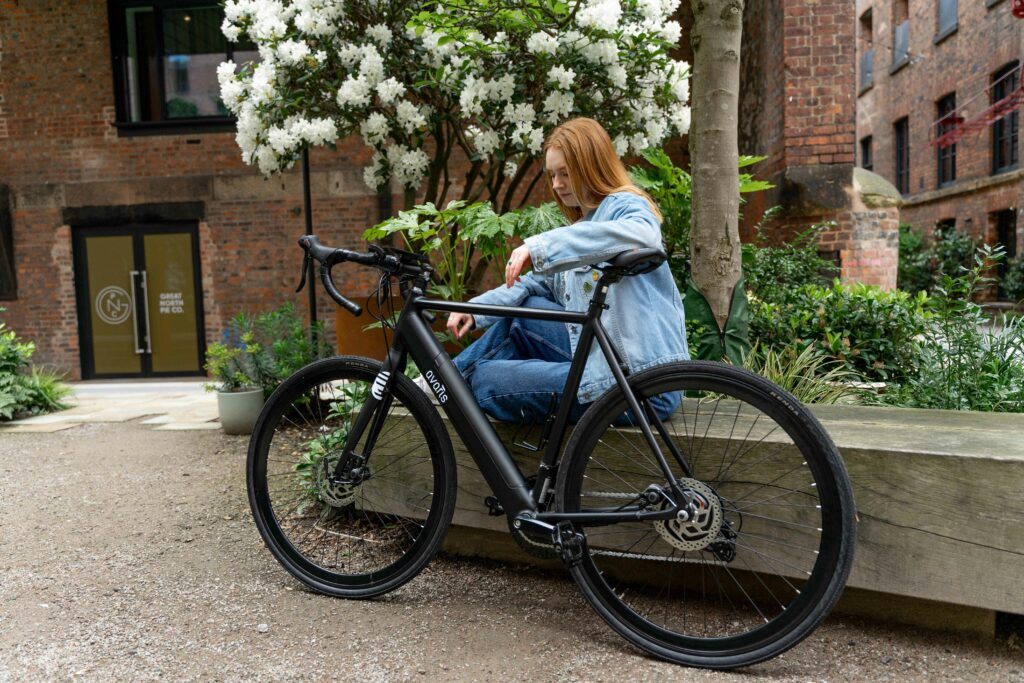 young woman next to an electrically assisted Avaris ebike 
